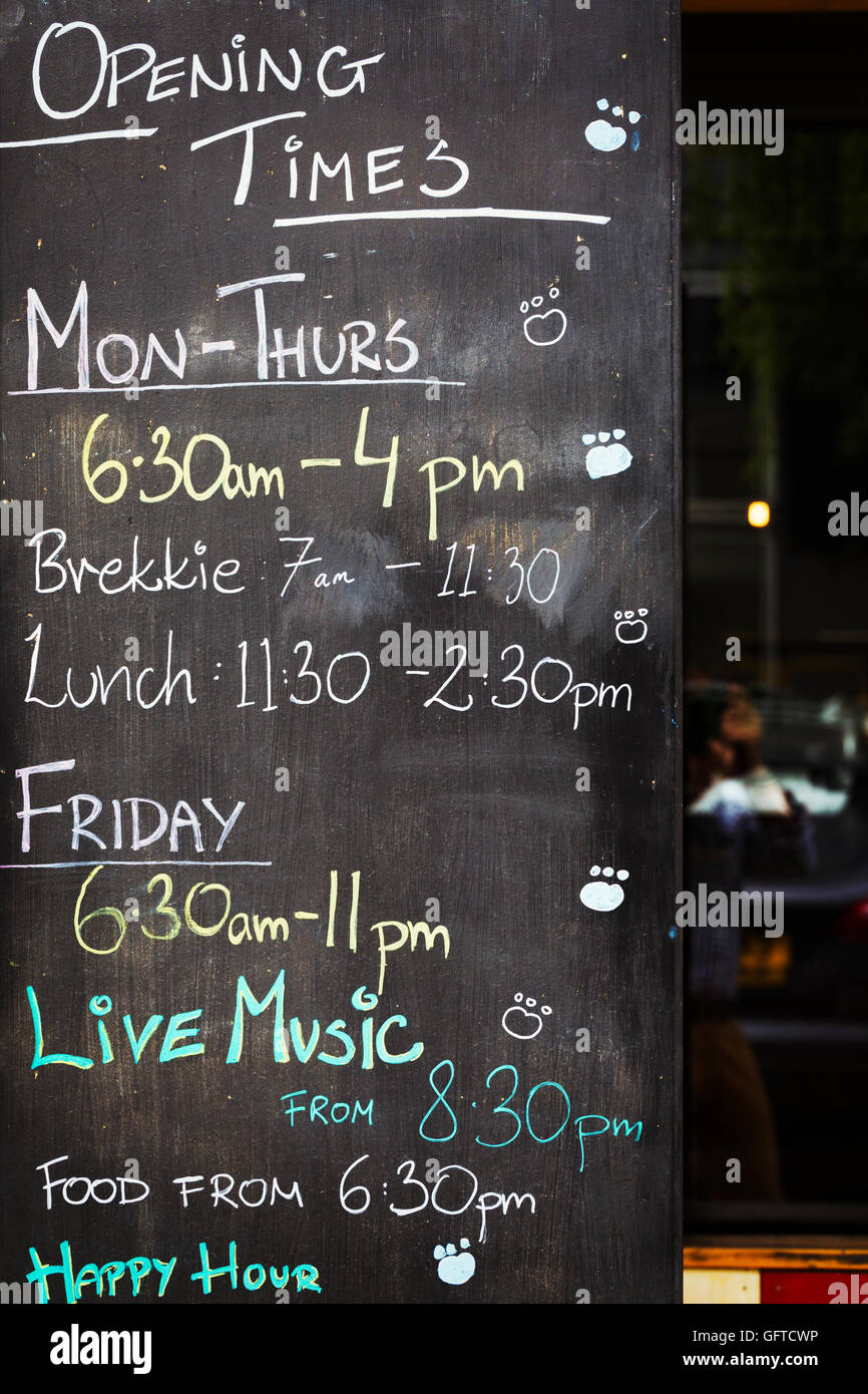 A chalk board with opening times and events listed Stock Photo Alamy