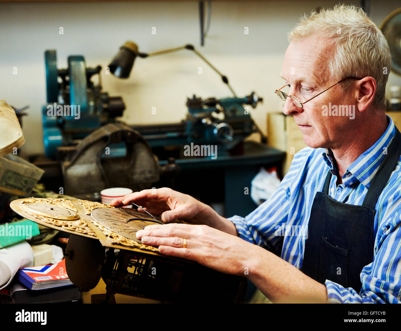 Clockwork Maker A clock maker busy in his workshop Stock Photo - Alamy
