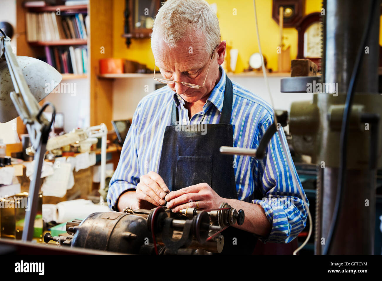 A clock maker busy in his Stock Photo Alamy
