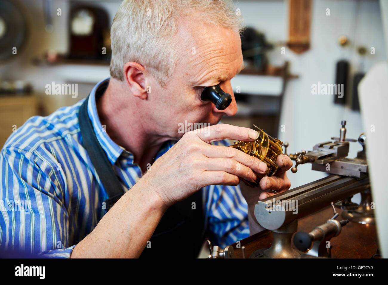 A clock maker busy in his Stock Photo Alamy