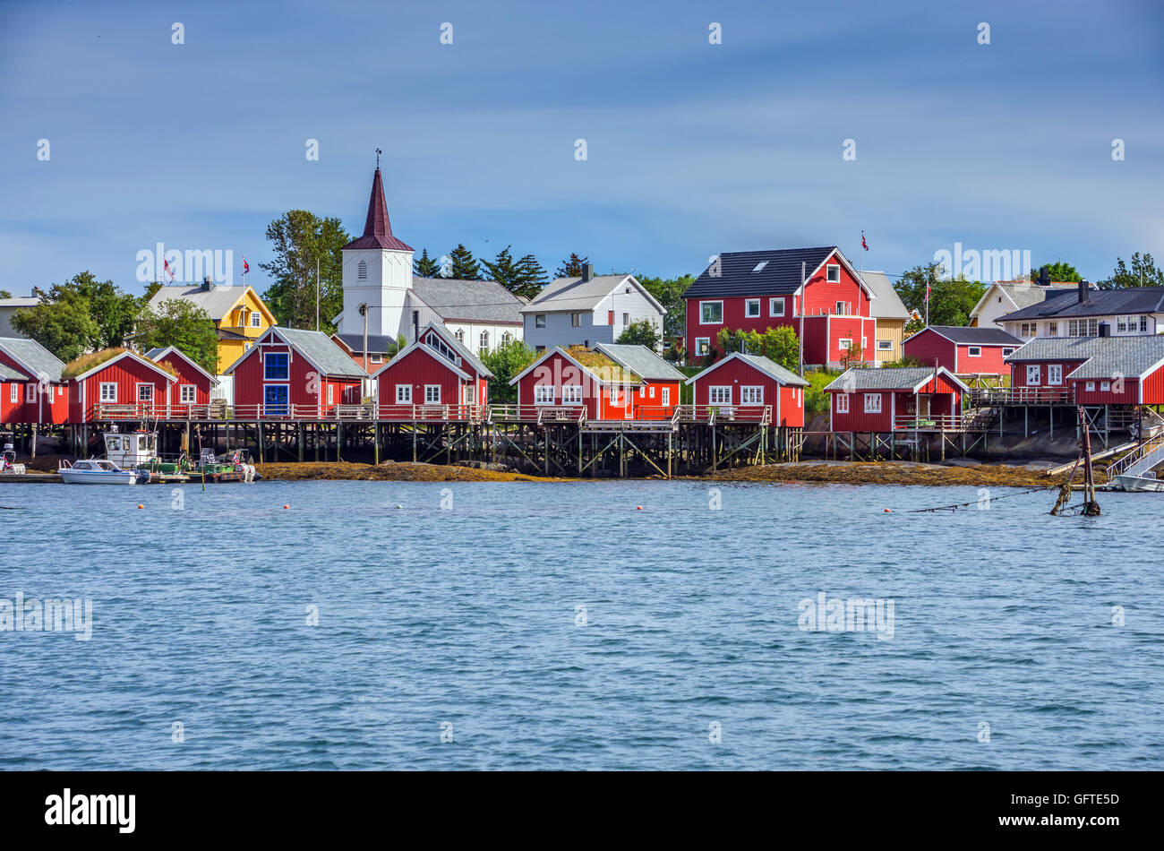 Red Rorbu,  Reine, Lofoten Islands, with white wooden church, Arctic, Norway, Scandinavia, Europe Stock Photo