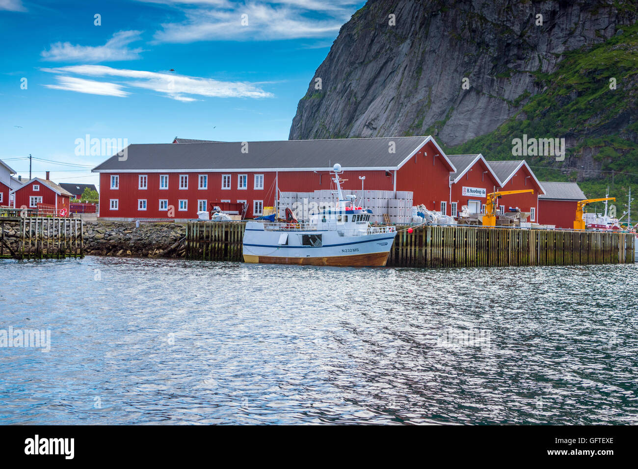 Red Rorbu and fishing boat and red fishing buildings Lofoten Islands, Arctic, Norway, Scandinavia, Europe Stock Photo