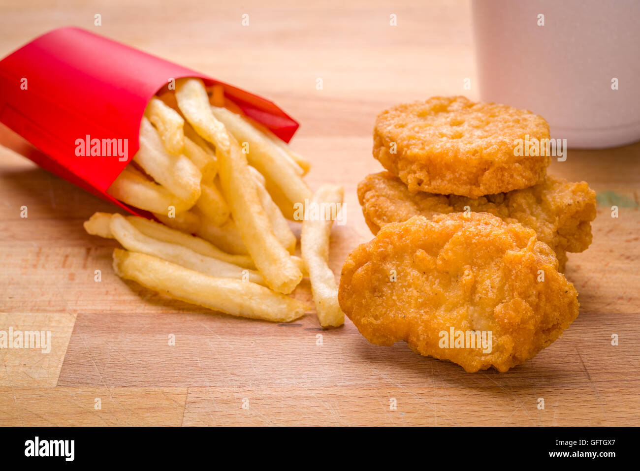 Kids, Child meal Golden brown Chicken nuggets and French fries on a wood background Stock Photo