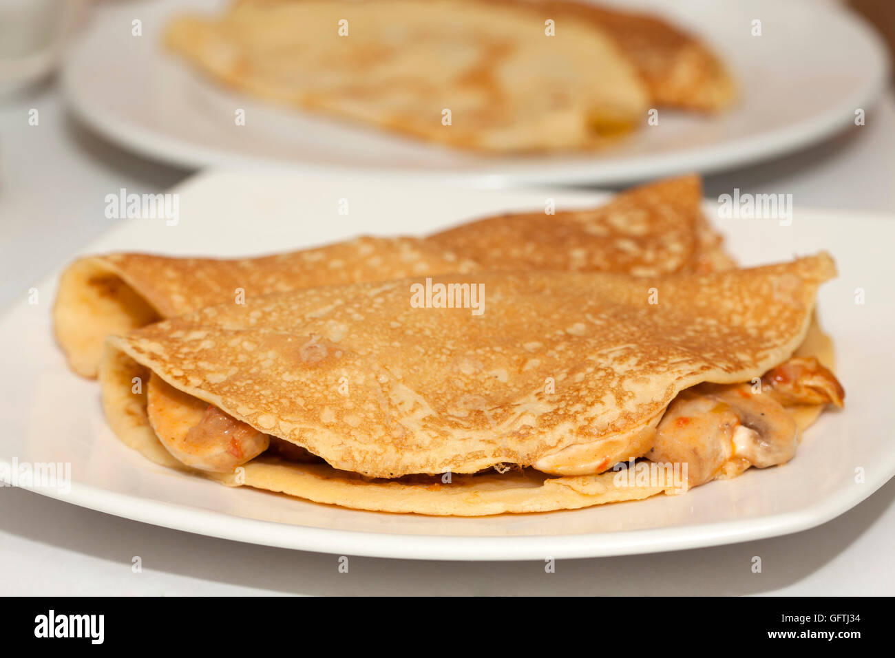Cooked crepes filled with chicken and mushrooms Stock Photo - Alamy