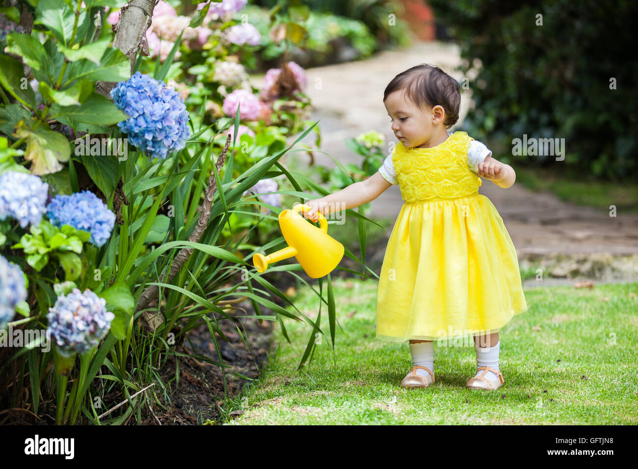 Little baby girl watering the plants Stock Photo Alamy