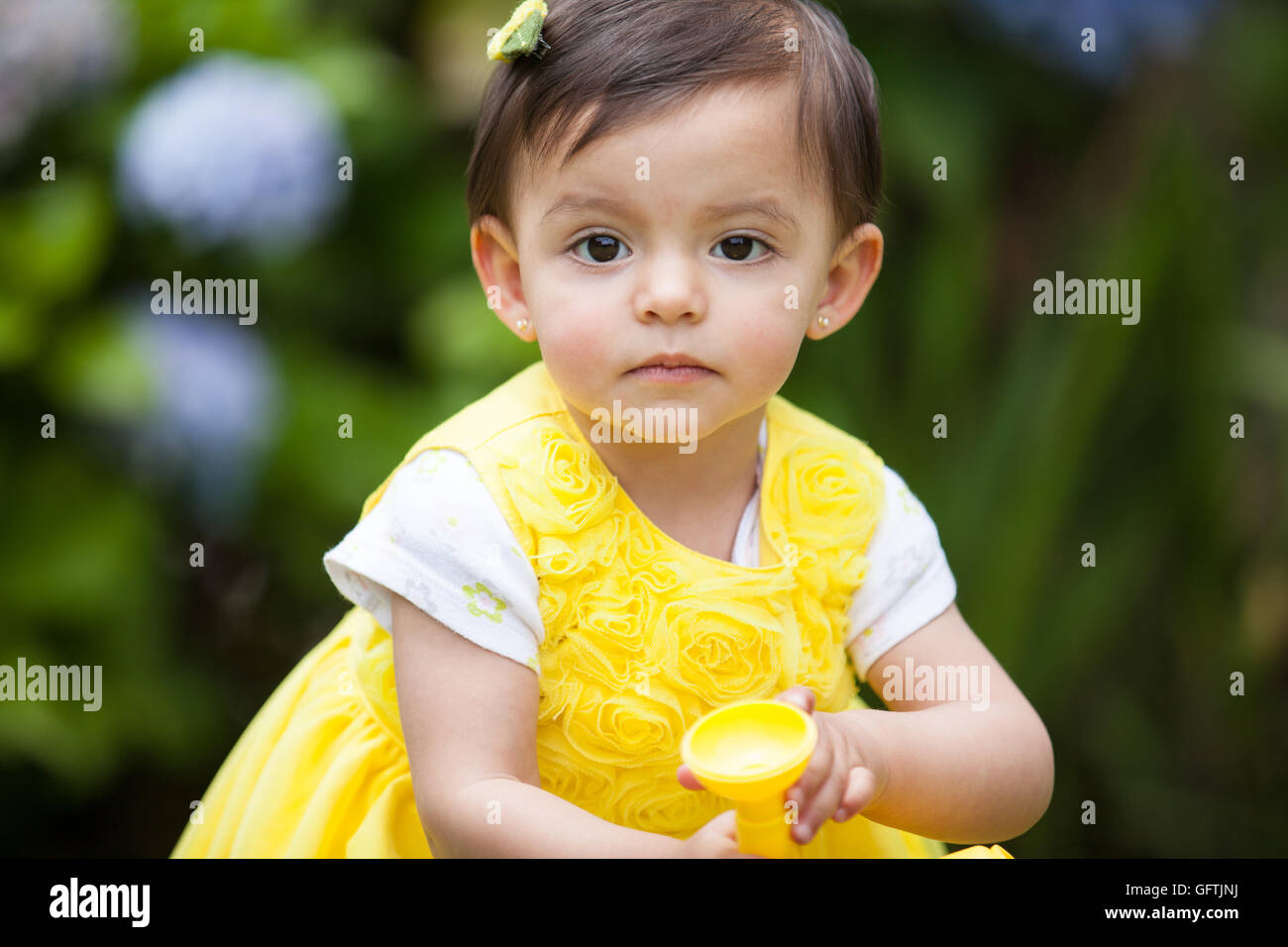 Little baby girl watering the plants Stock Photo Alamy
