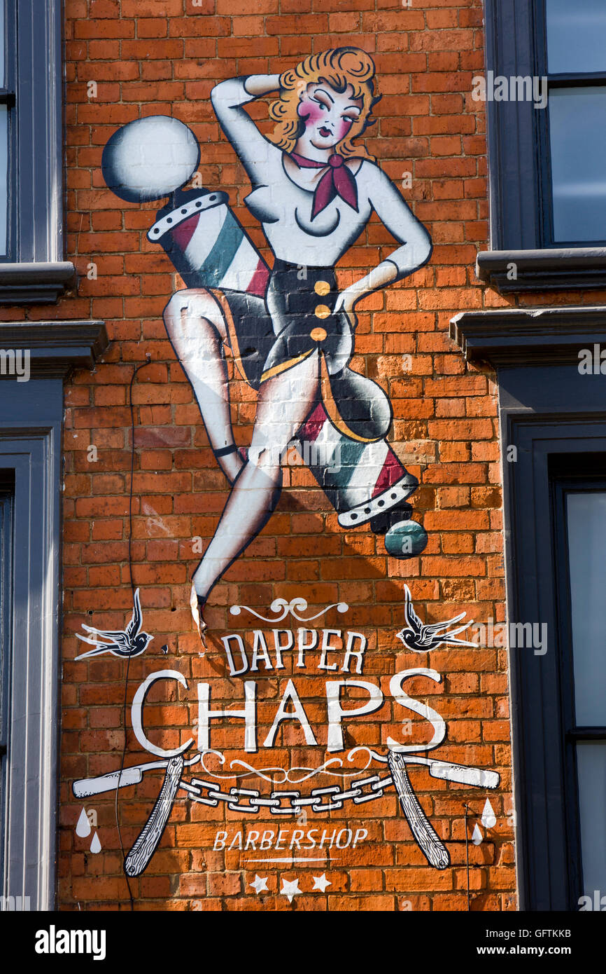 UK, England, Northamptonshire, Northampton, Derngate, ‘Dapper Chaps’ barber’s salon sign painted on shop wall Stock Photo