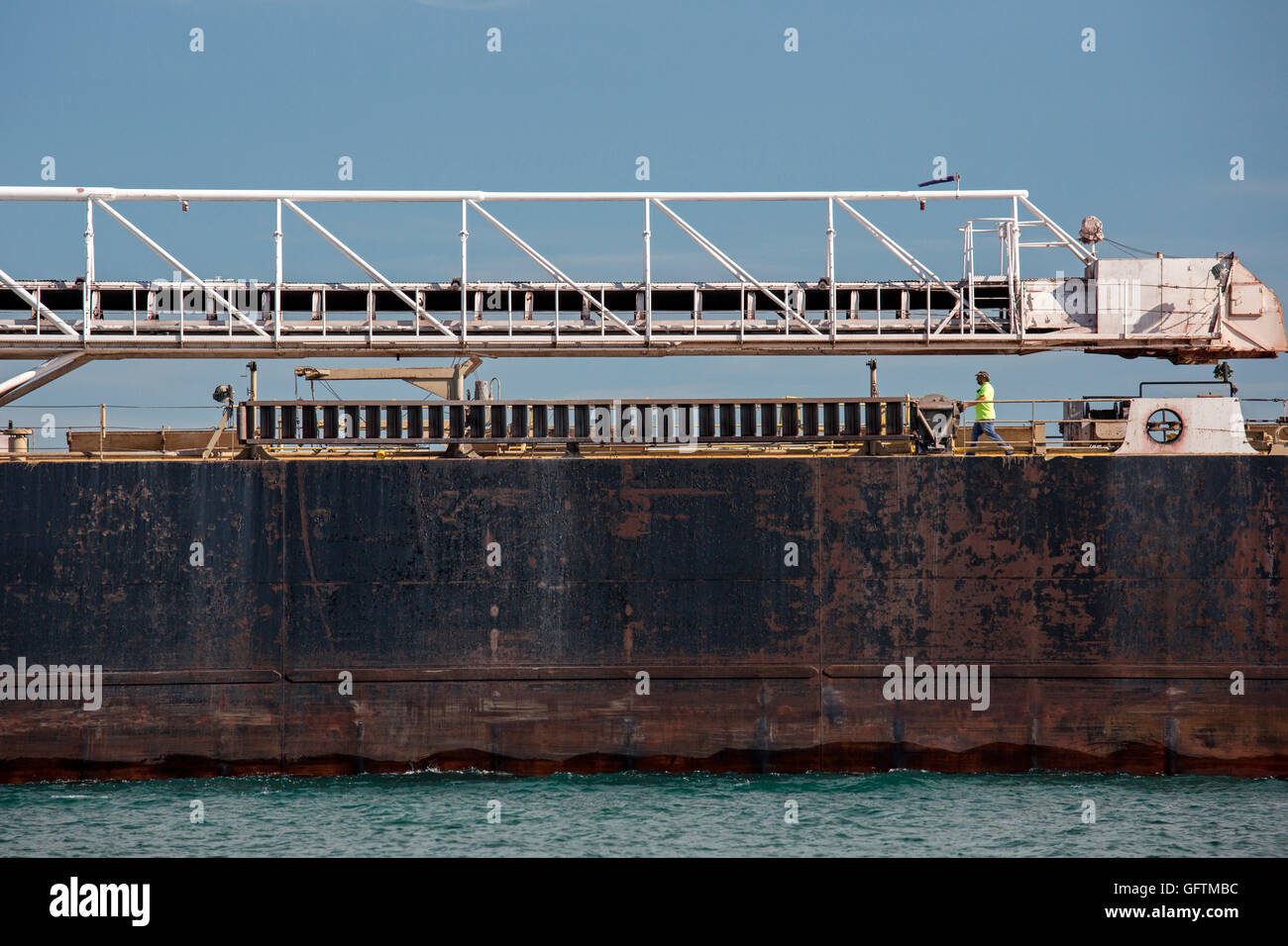 Detroit, Michigan - A crew member walks on the deck of the American Mariner bulk carrier sailing on the Detroit River. Stock Photo