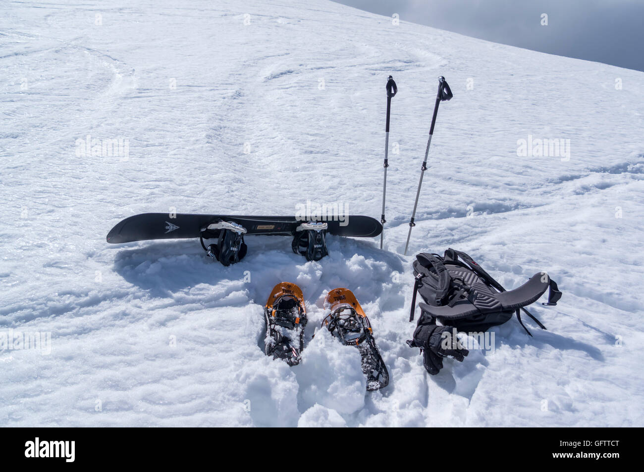 Winter backcountry gear in the snow, consisting of snowshoes and