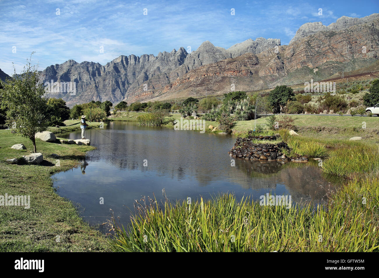 A Fish pond for trout in Du Toitskloof Pass, Worcester, Western Cape in South Africa at du kloof with reflections of witteberg mountains Stock Photo
