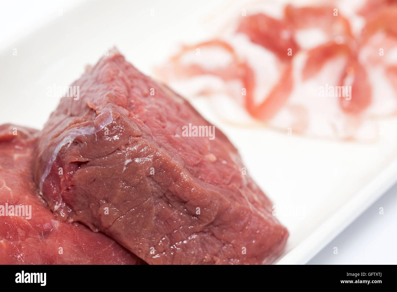 Raw medallions of beef tenderloin and pork bacon Stock Photo