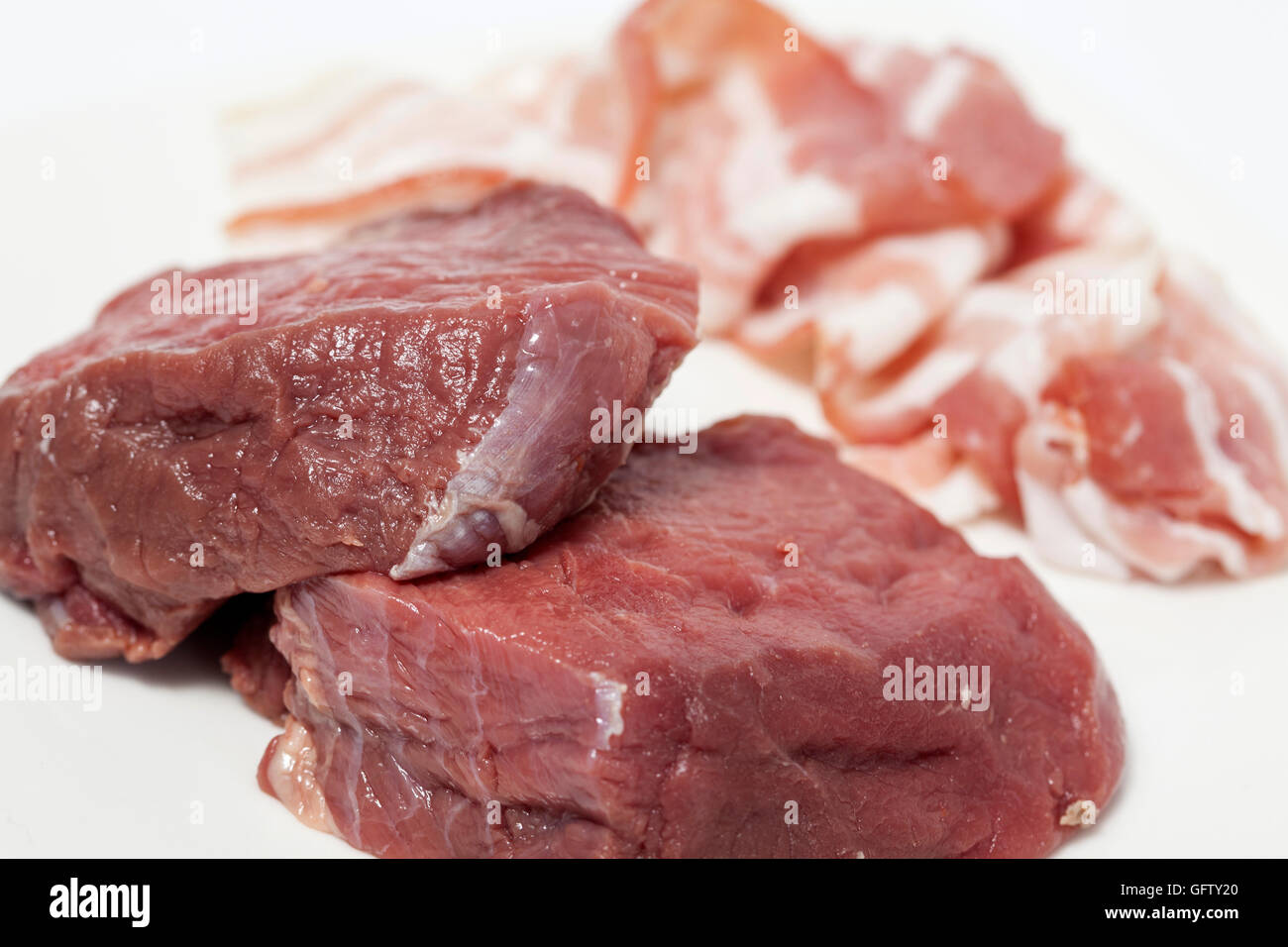 Raw medallions of beef tenderloin and pork bacon Stock Photo