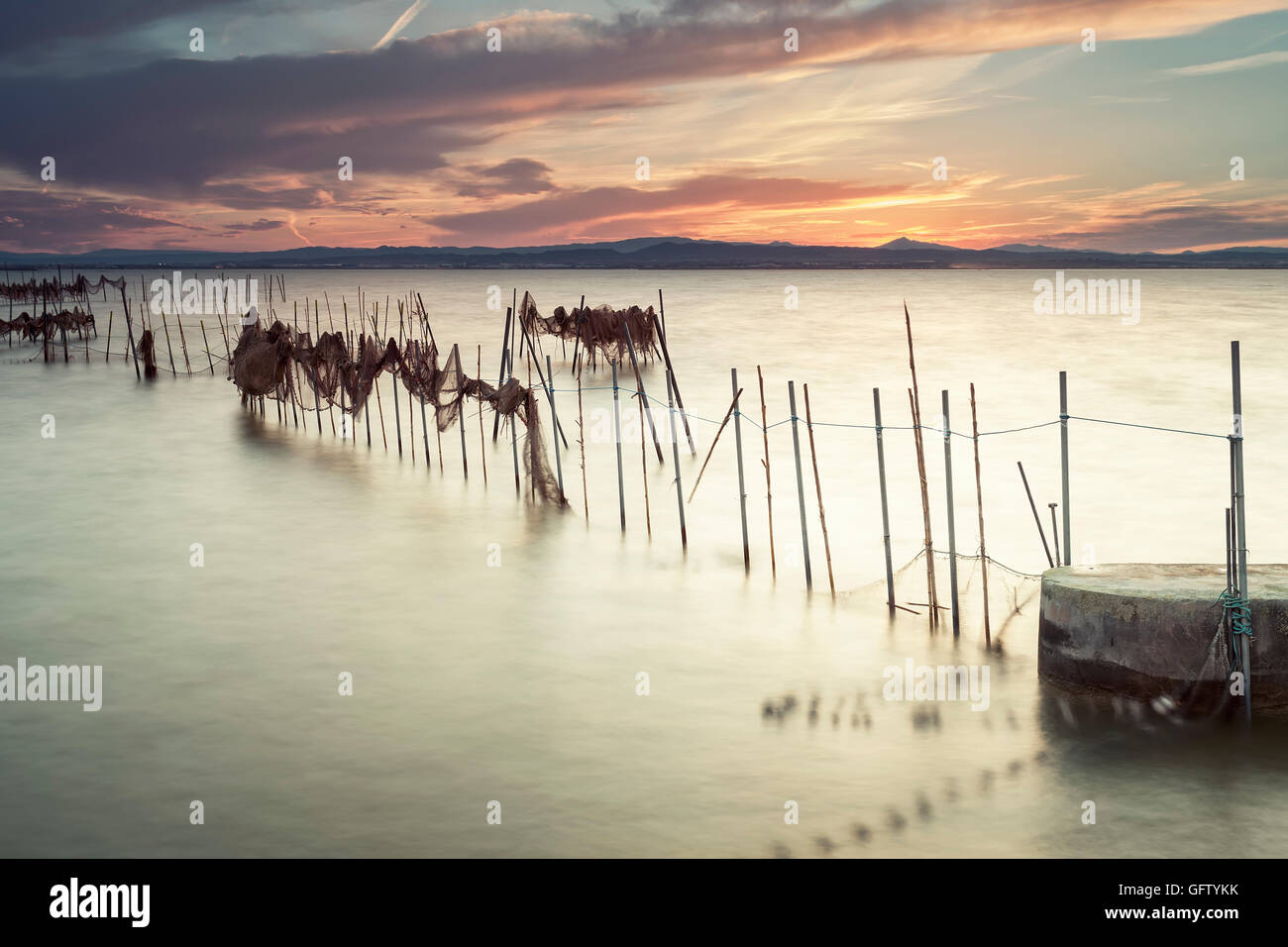 Sunset on the Albufera Nature Park, Valencia, Spain, with fishing nets Stock Photo