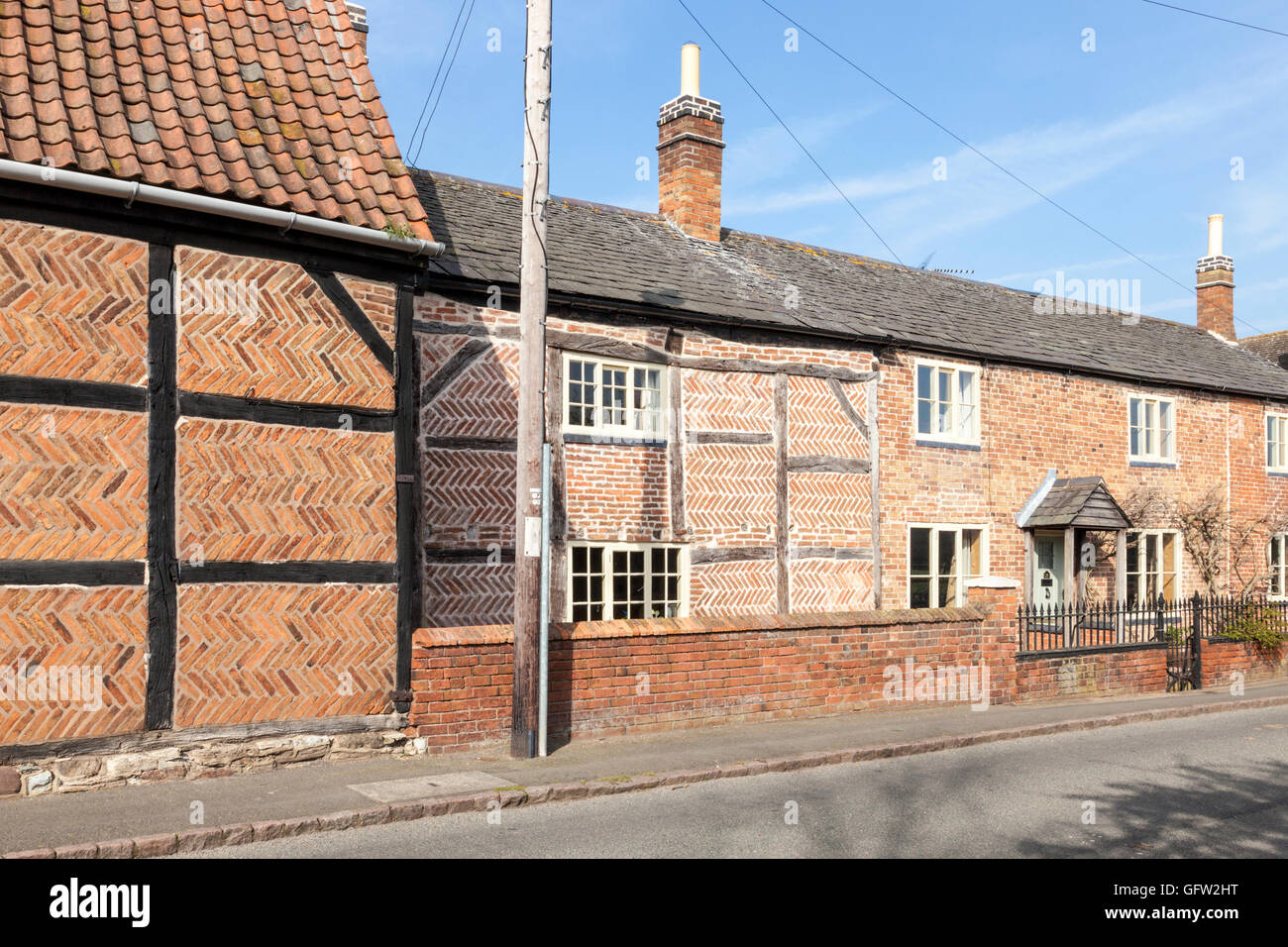 Various brickwork patterns, including herringbone, on a timber framed cottage and other buildings, Hoton, Leicestershire, England, UK Stock Photo