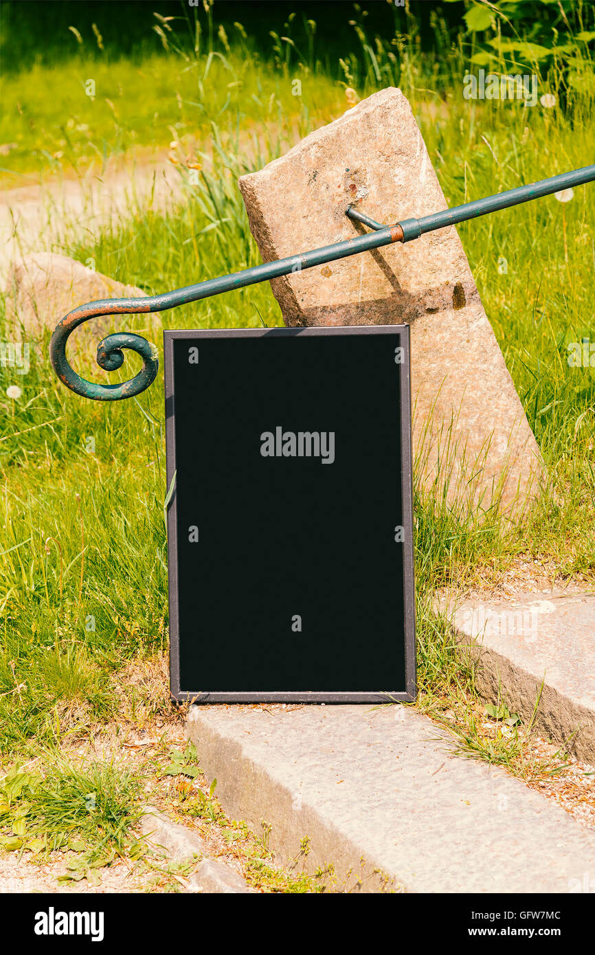 Image of a blackboard frame mockup in a park environment. Stock Photo