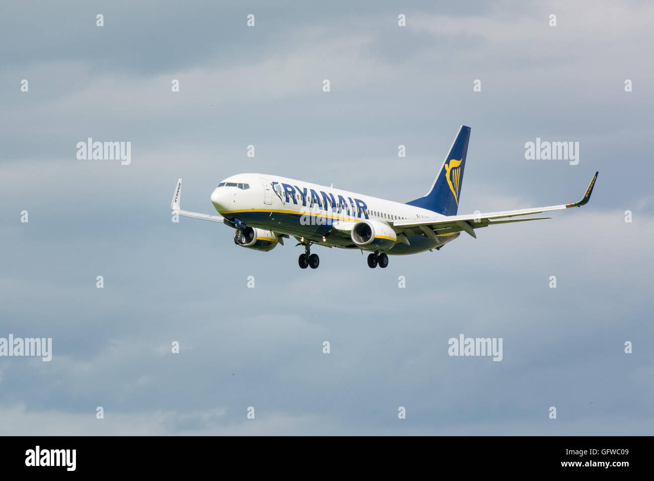 Ryanair plane flying in the air with landing wheels down Stock Photo