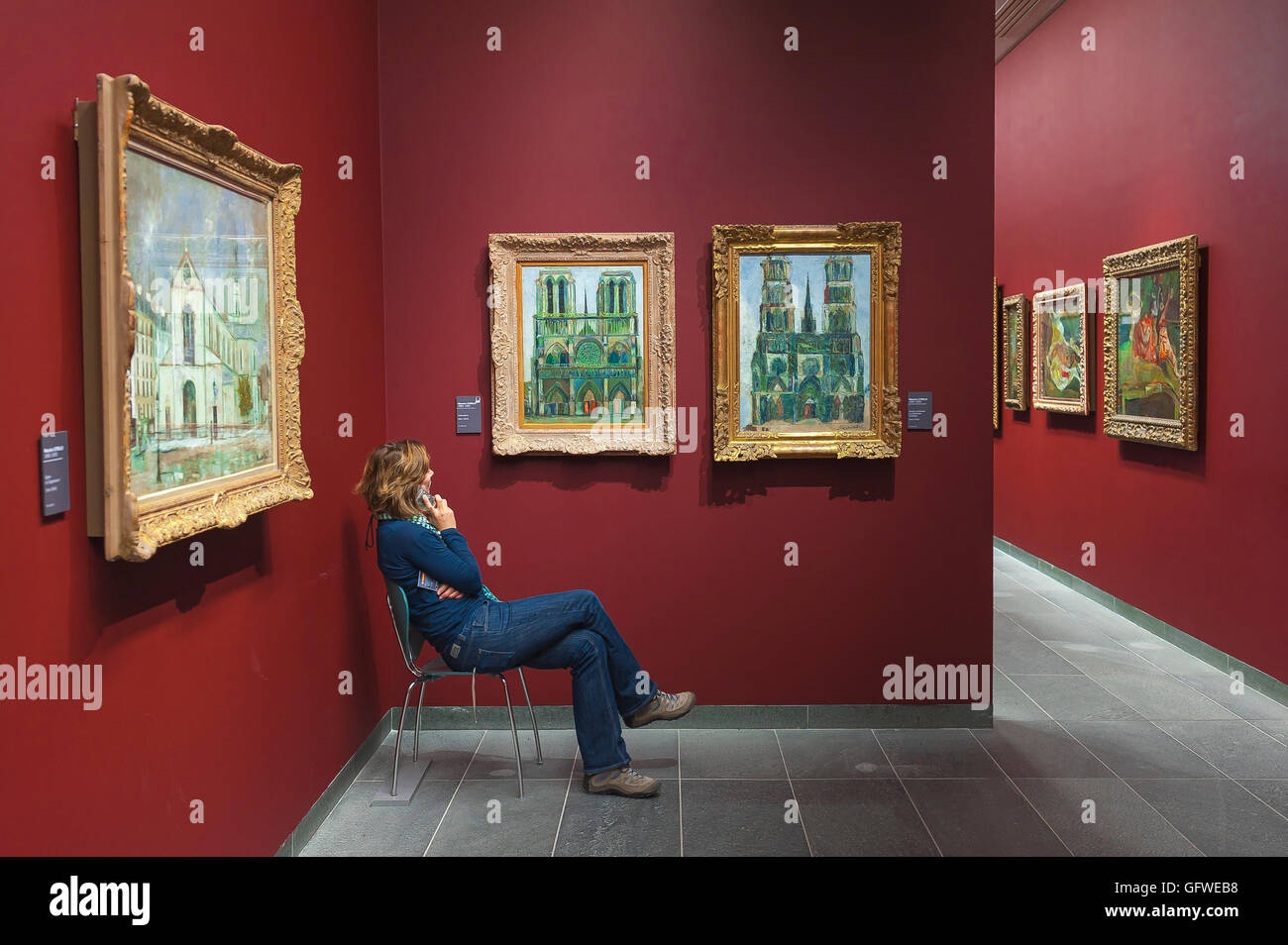 Paris Orangerie Museum, a female tourist listens to information about the paintings of Utrillo in the Musee de l'Orangerie in Paris, France. Stock Photo