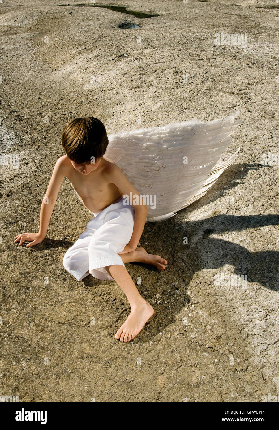 A young boy wearing angel wings. Stock Photo