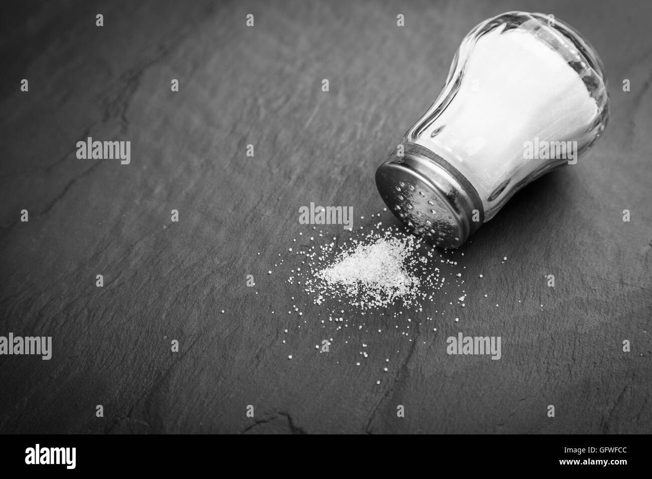 Salt shaker on slate board Stock Photo Alamy