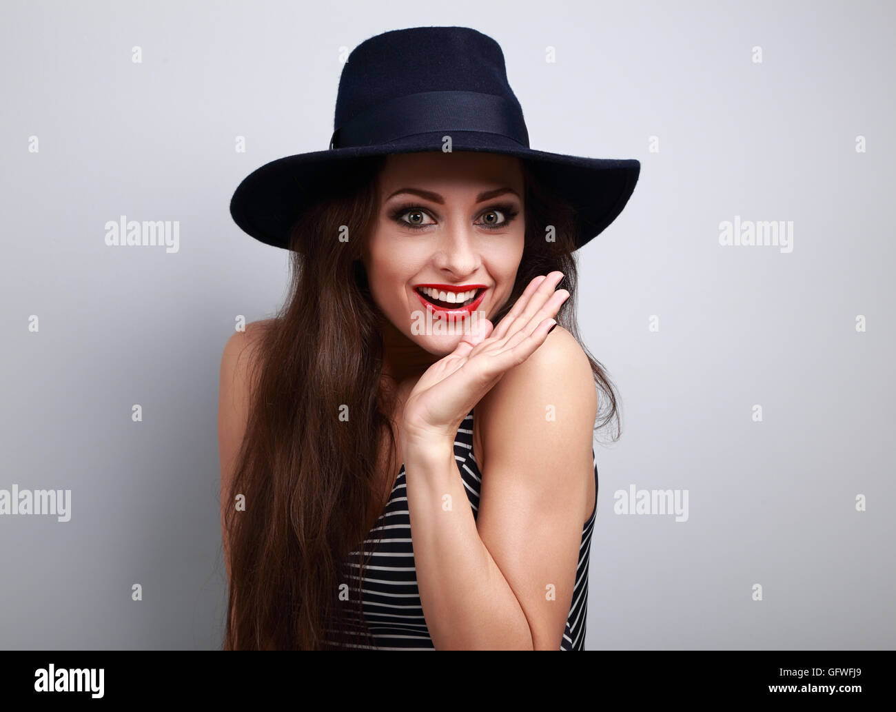 Happy bright makeup surprising woman looking fun in fashion blue hat with empty copy space Stock Photo
