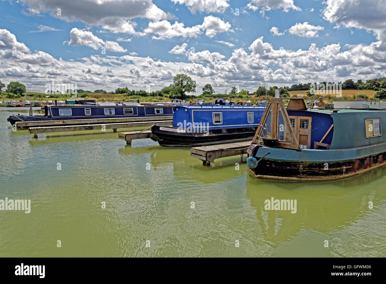 narrowboats in Marina with white fluffy  clouds Stock Photo