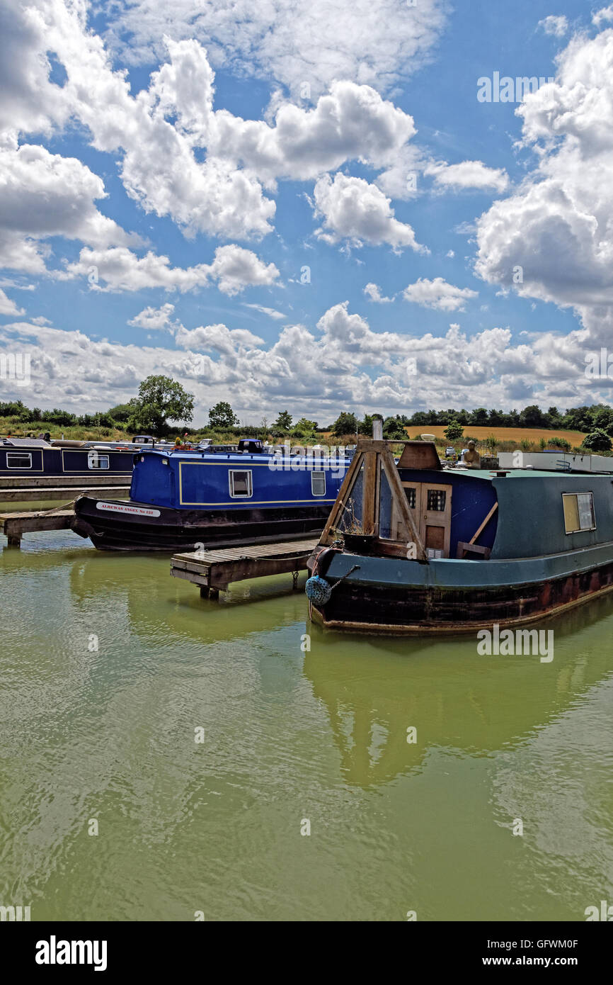 narrowboats in Marina with white fluffy  clouds Stock Photo