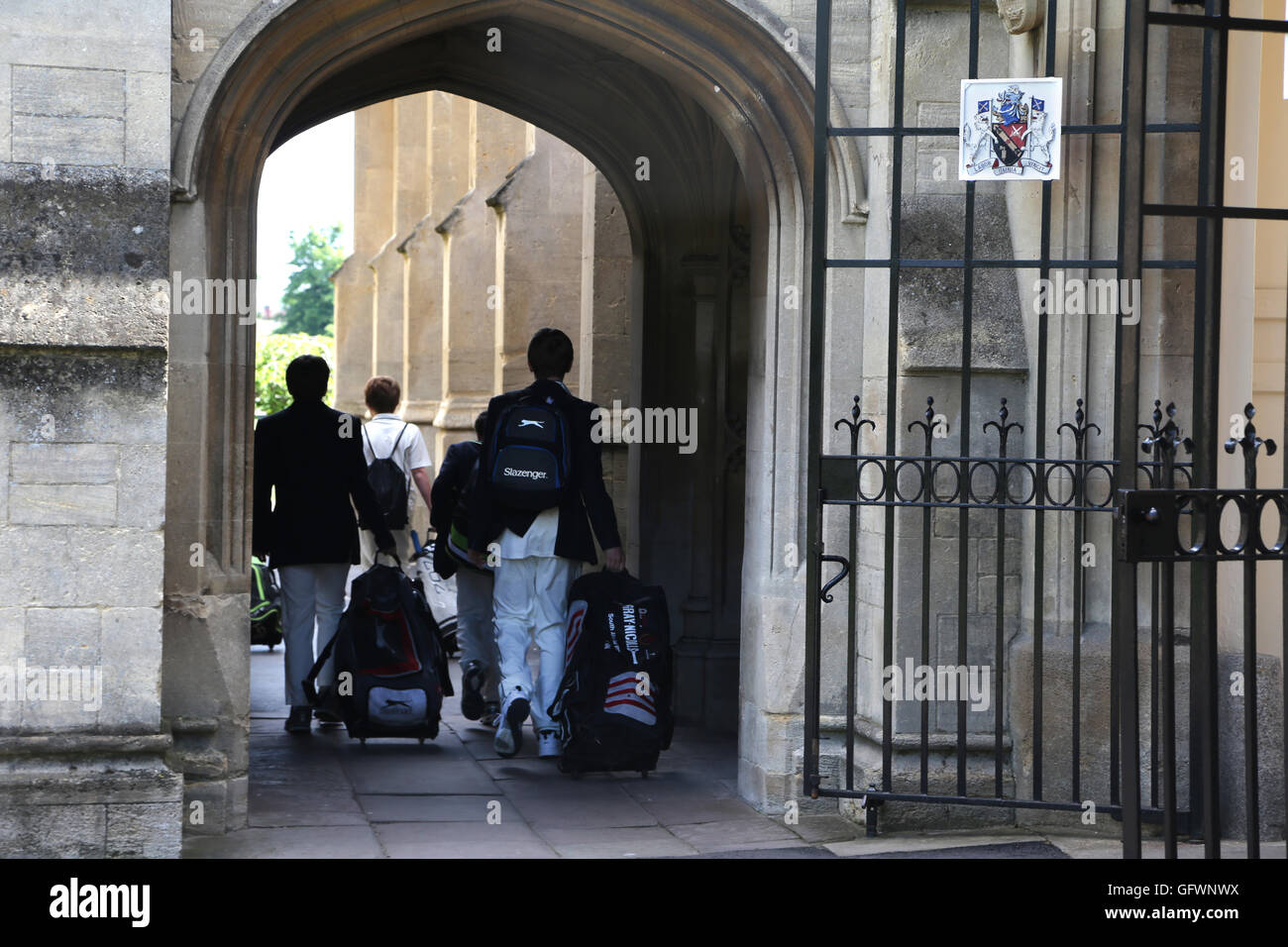 Cheltenham Gloucestershire England Cheltenham College Students With Bags Walking Through Archway Stock Photo
