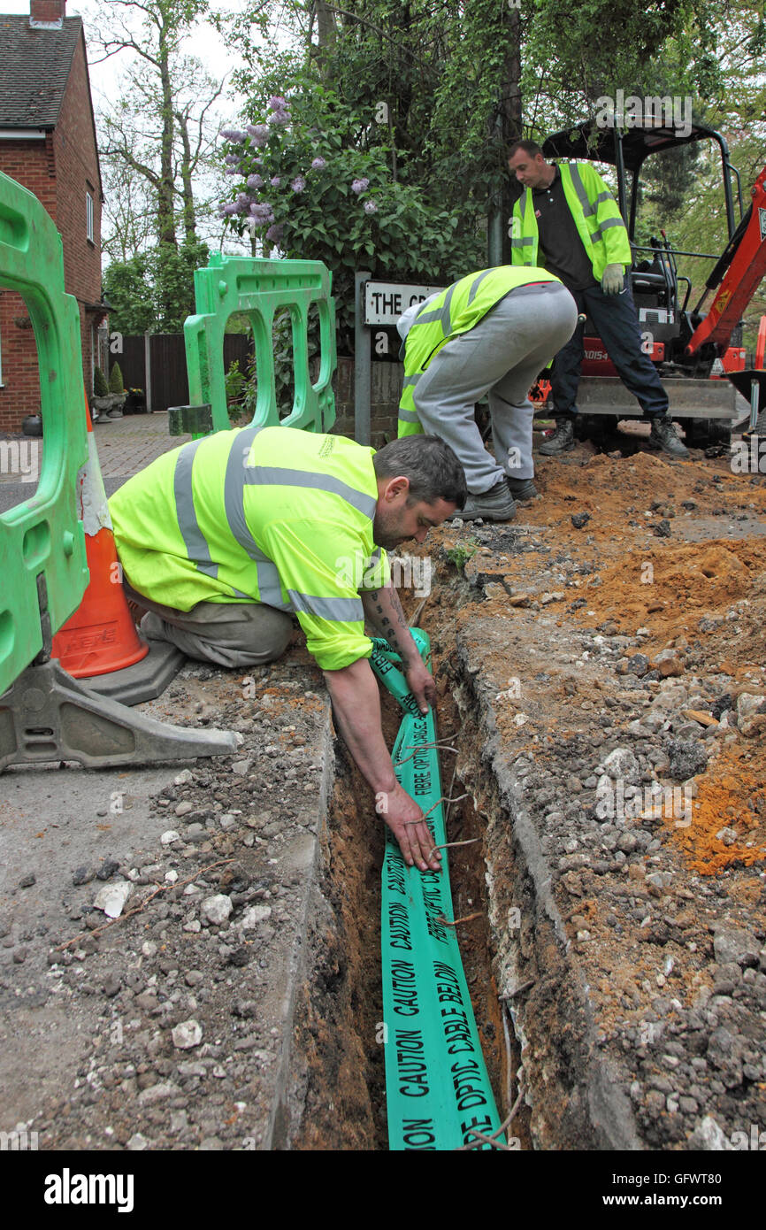 Workmen lay new fibre-optic cables for high speed broadband in a rural part of Kent, UK Stock Photo