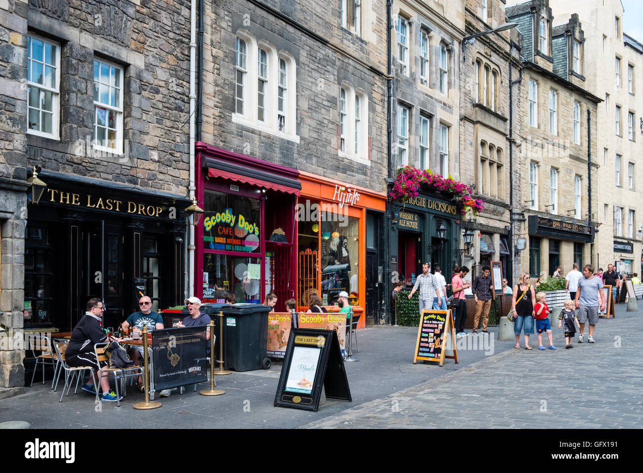 View of pubs and cafes along historic street in Grassmarket district of ...