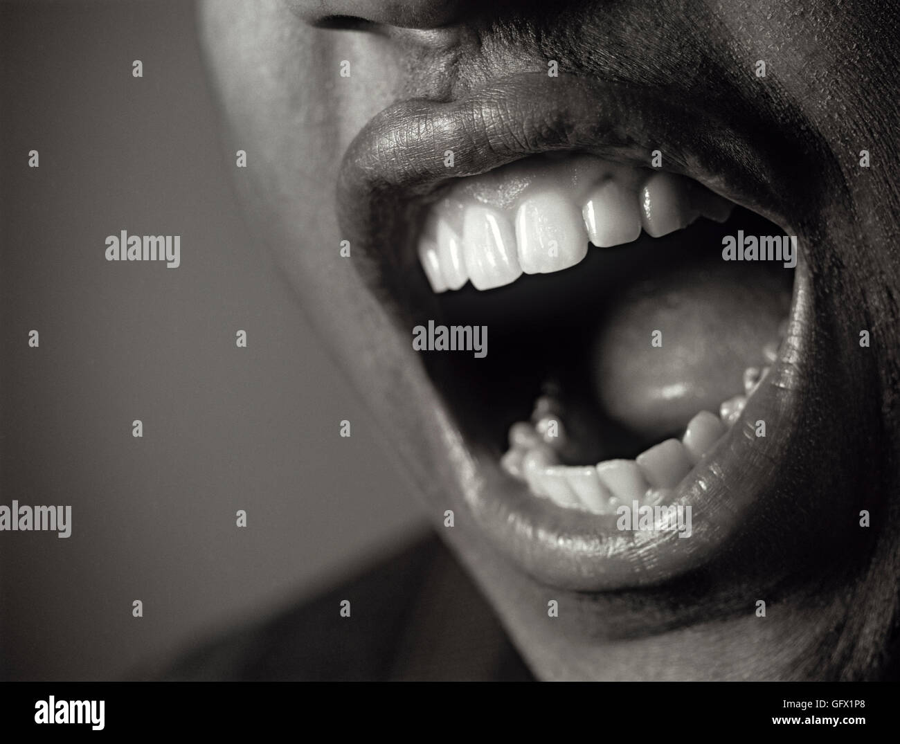 Closeup of man screaming or yelling with a wide mouth Stock Photo