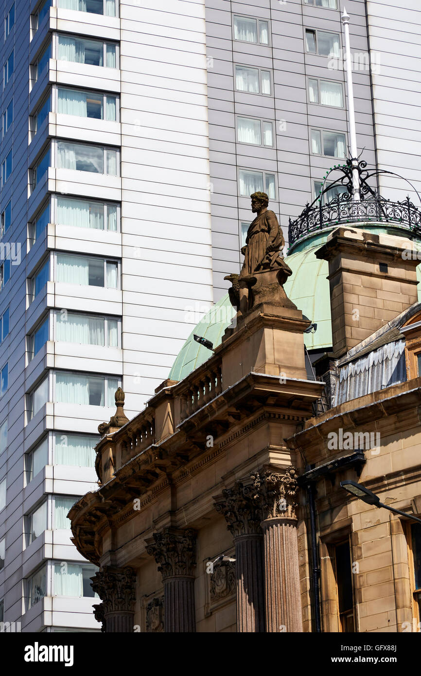 Statue on old bank building City Square Leeds against high-rise apartment block. Stock Photo