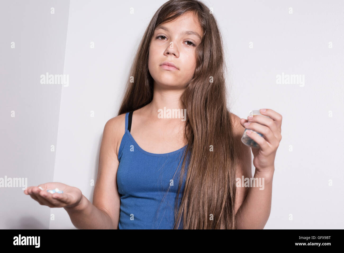 Depressed teenager with pills Stock Photo