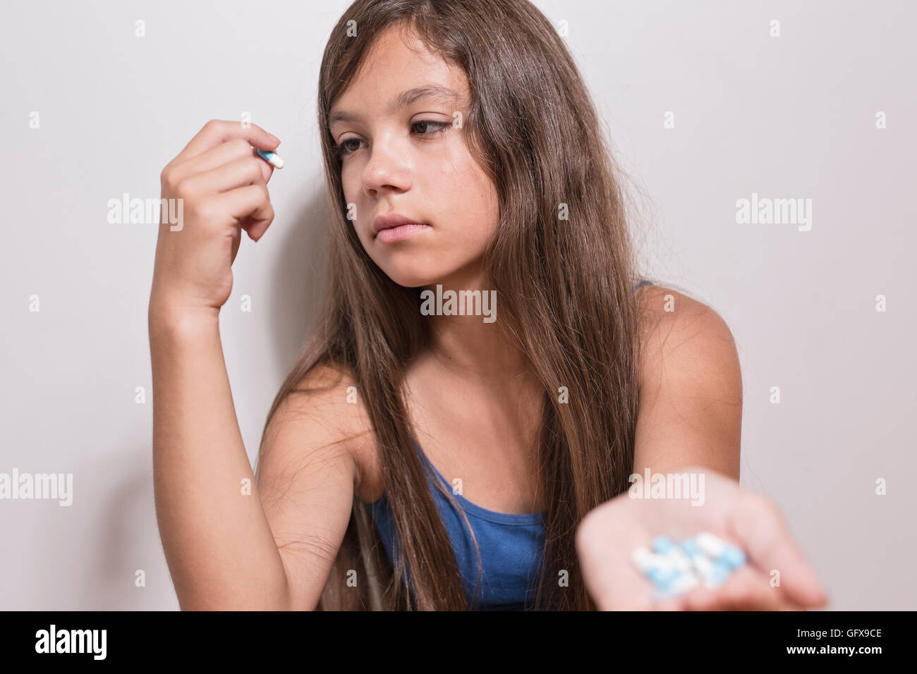 Depressed teenager with pills Stock Photo