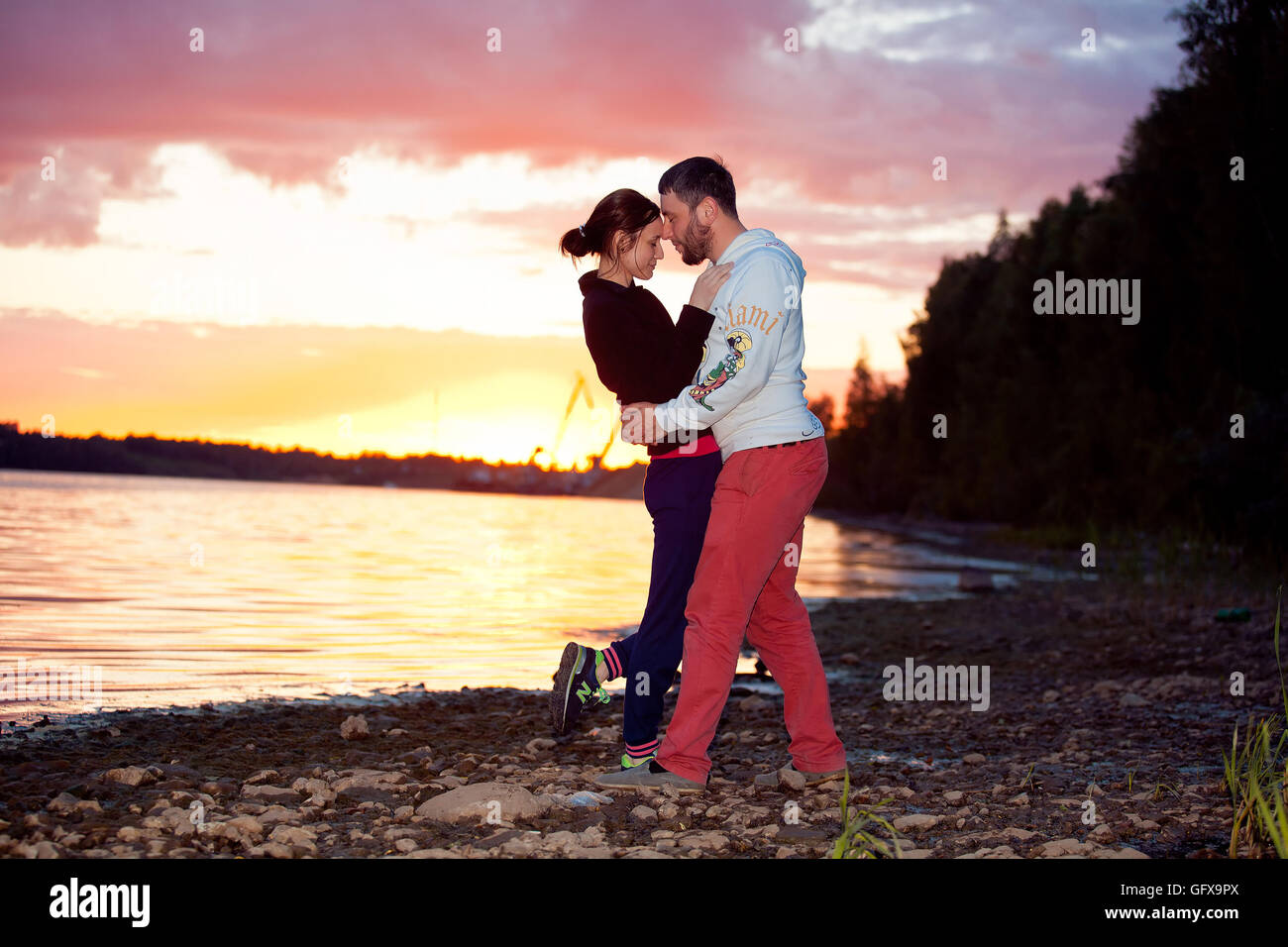 Couple in love, enjoying in nature at the sunset Stock Photo - Alamy