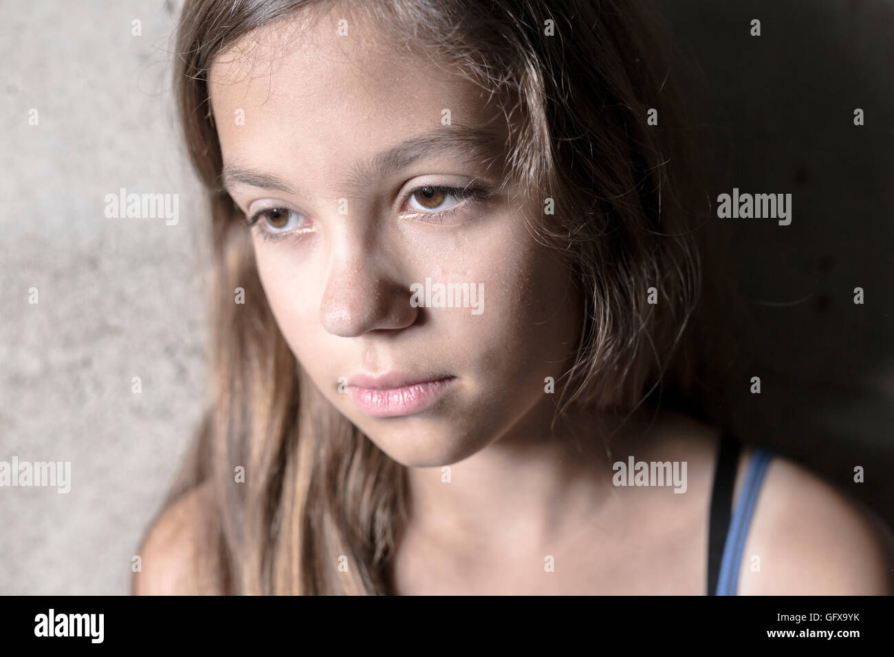 Sad and lonely girl beside wall Stock Photo - Alamy