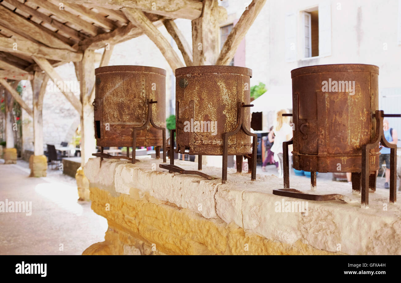 The famous market square with old tin weighing buckets in beautiful  bastide of Monpazier in Dordogne Region of France Stock Photo