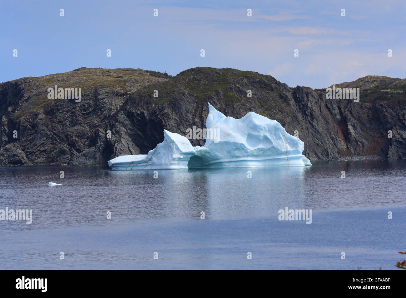A jagged iceberg next to Burnt Island on Twillingate Harbour, North Twillingate Island, Newfoundland and Labrador, Canada. Stock Photo