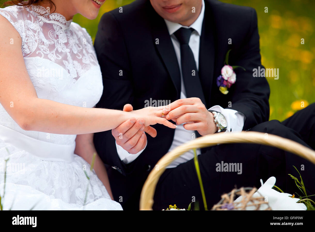 The groom wears the ring bride. Engagement. Wedding day. Wedding ring ...