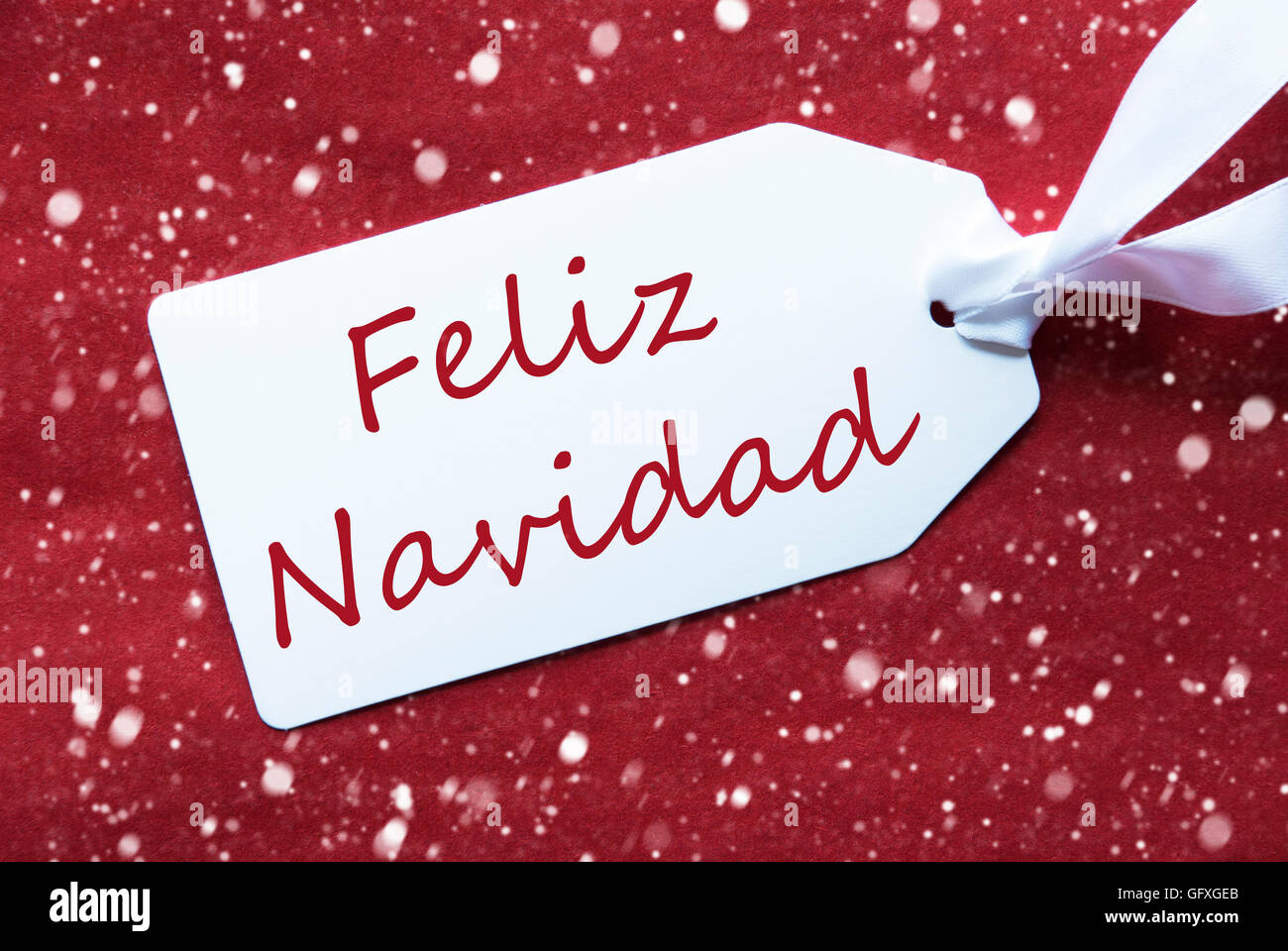 Label On Red Background, Snowflakes, Feliz Navidad Means Merry Christmas Stock Photo