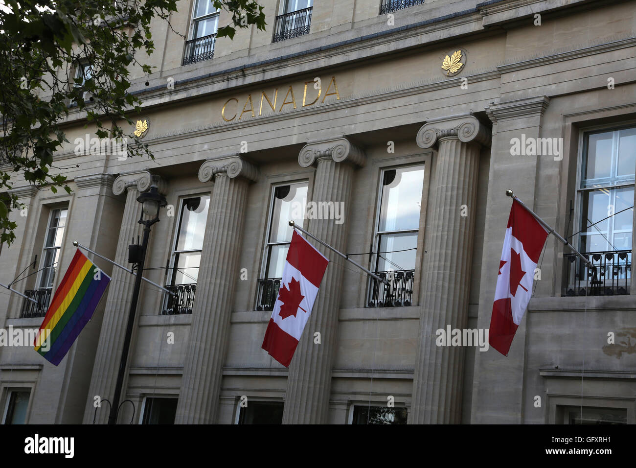 London England Trafalgar Square Canada House With Canadian Flags And The Gay Pride Flag Flying Stock Photo