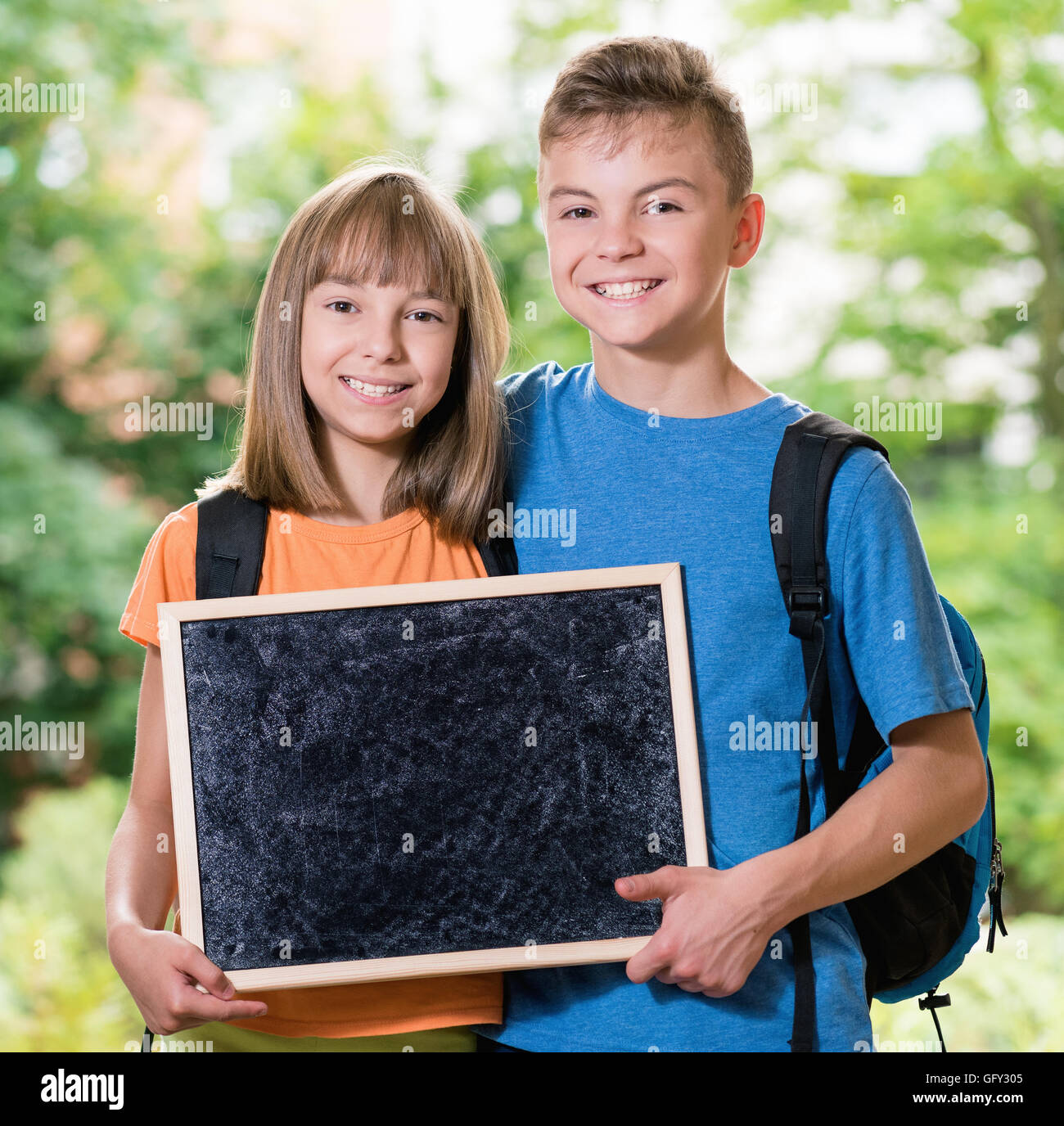Boy and girl with blackboard Stock Photo