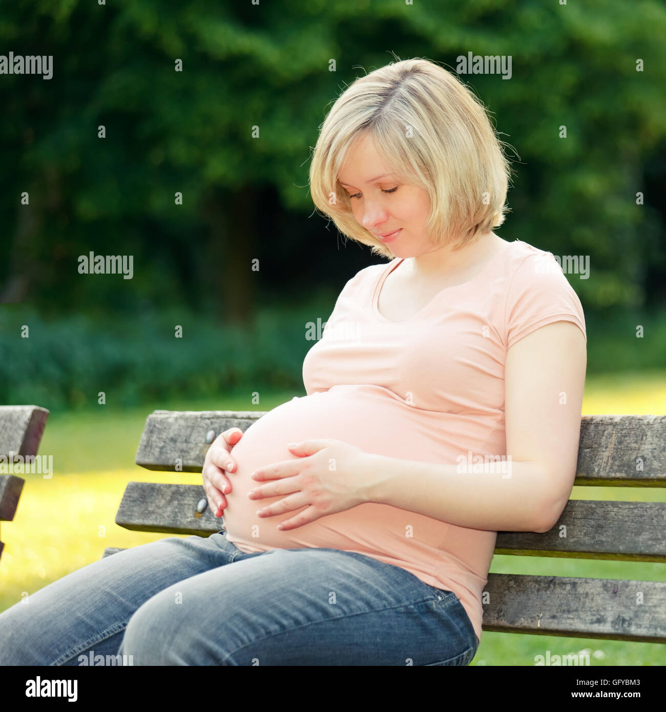 Pregnant woman in the park Stock Photo - Alamy