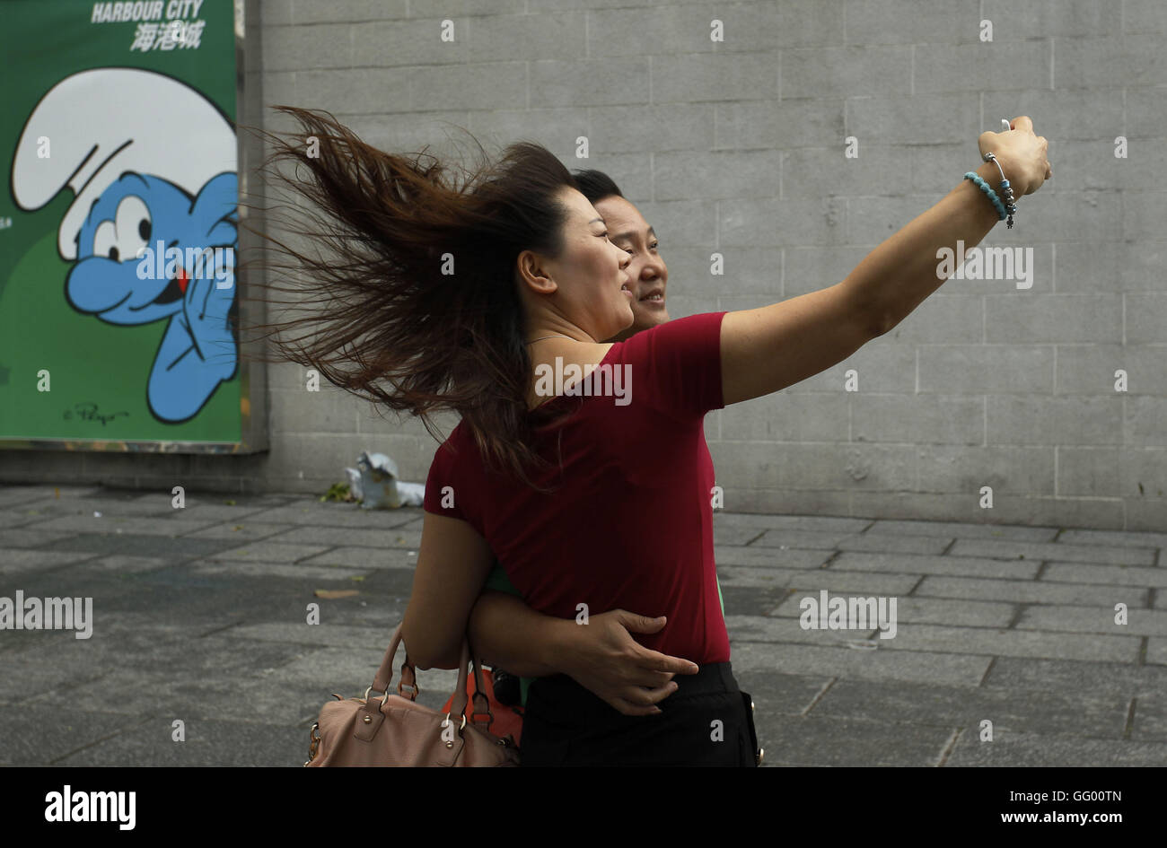 Tourists take selfies under the windy weather by the sea. First major tropical cyclone this year, No.8 Typhoon NIDA passed through Hong Kong overnight but not leaving serious damage and dissipated as it moved towards westwards around the coastal cities in Guang Dong Province. Aug 2, 2016. Hong Kong. 2nd Aug, 2016. Liau Chung Ren/ZUMA © Liau Chung Ren/ZUMA Wire/Alamy Live News Stock Photo