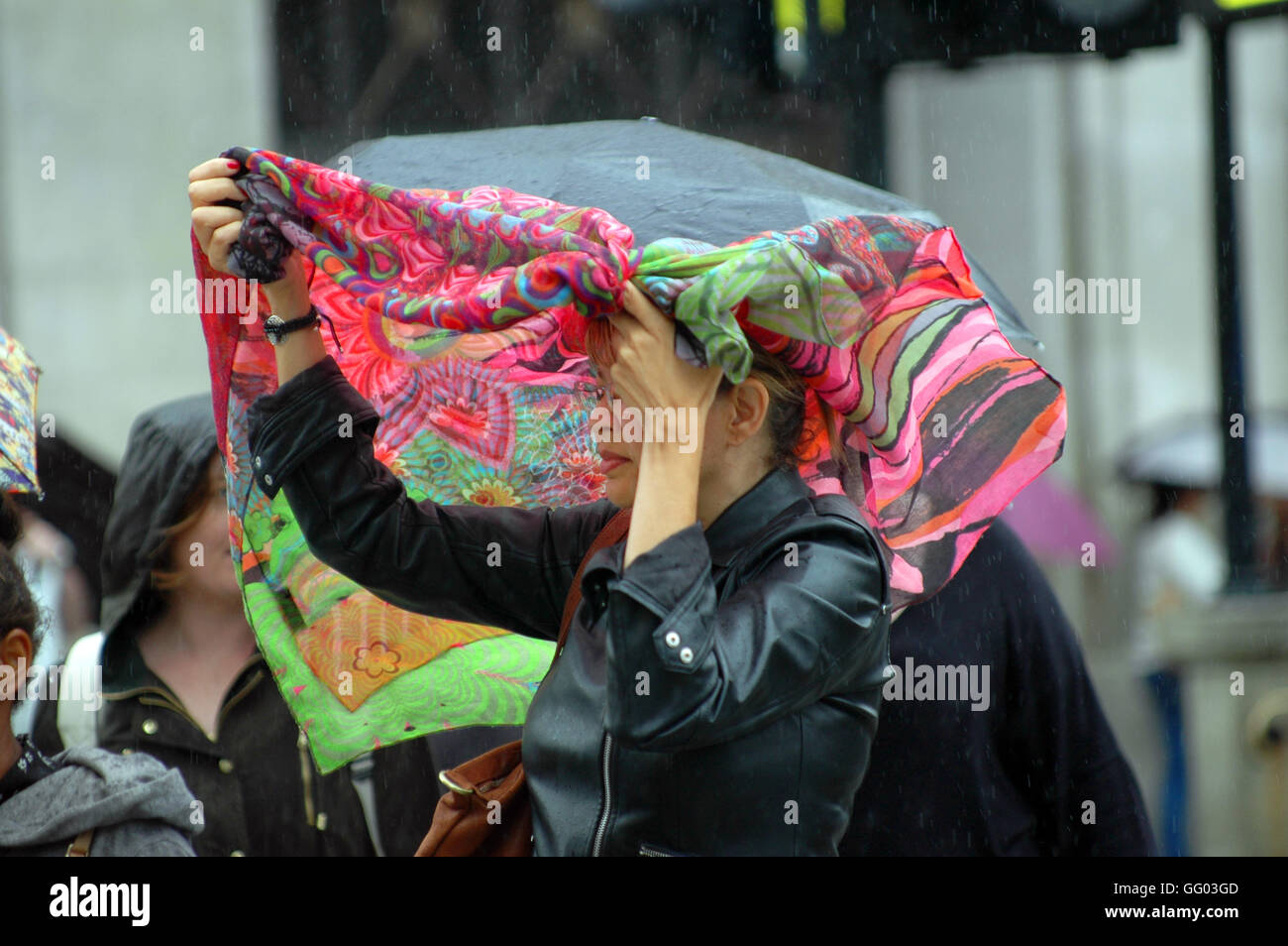 Oxford Circus, London, UK. 2nd August, 2016. Heavy showers in Oxford Circus keeps shoppers running for cover. Credit:  JOHNNY ARMSTEAD/Alamy Live News Stock Photo