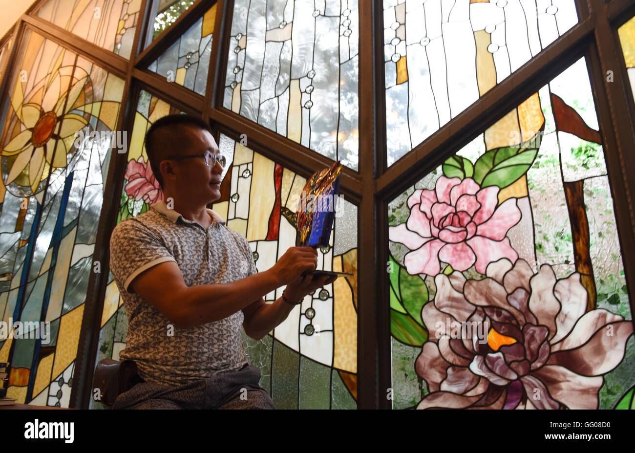 Nantou, China's Taiwan. 2nd Aug, 2016. Coloured glaze artist Lin Fang-Shih works at his studio in Nantou County, southeast China's Taiwan, Aug. 2, 2016. Lin Fang-Shih, 43 years old, has indulged himself into coloured glaze artworks for 21 years and has made various unique artworks through hard work. © Song Zhenping/Xinhua/Alamy Live News Stock Photo