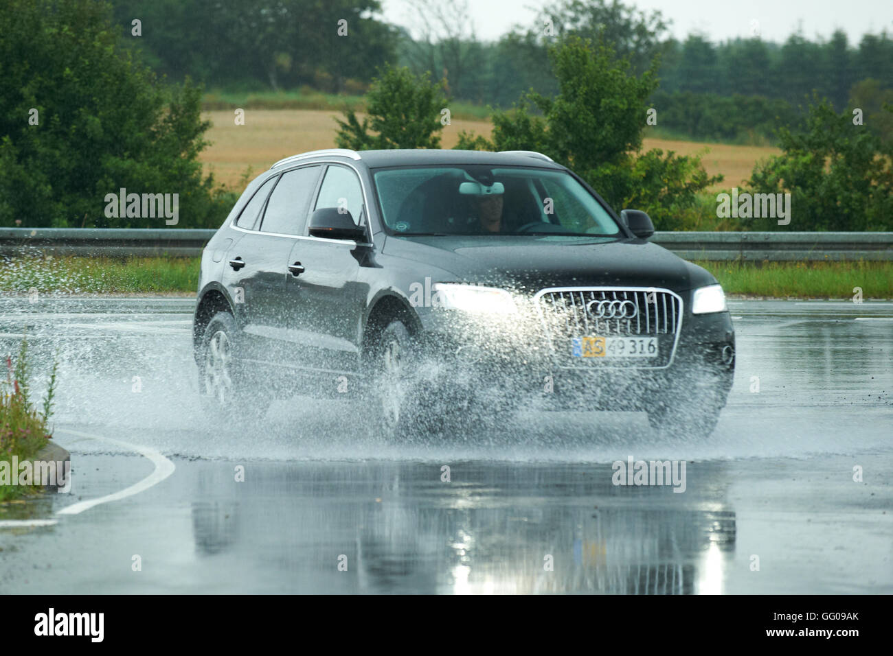 Viborg, Denmark 3rd August 2016: the nice summer weather was suddenly interrupted by thunder and lightning, followed by heavy rain showers. Lots of water on the roads suprised car drivers. Credit:  Brian Bjeldbak/Alamy Live News Stock Photo