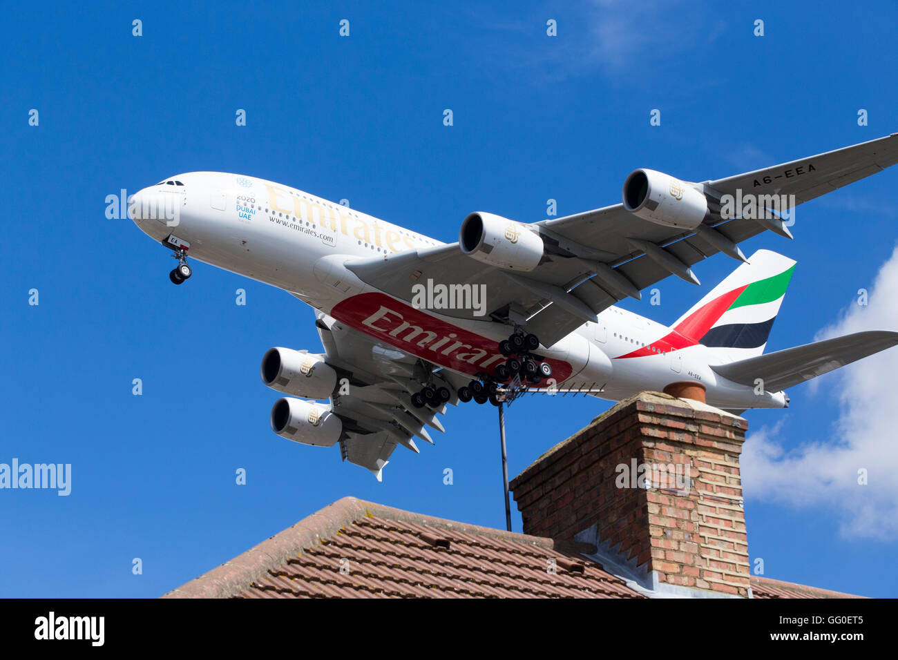 Emirates Airbus / Air Bus A380-861 A6-EEA plane landing over roof tops at London airport. Stock Photo