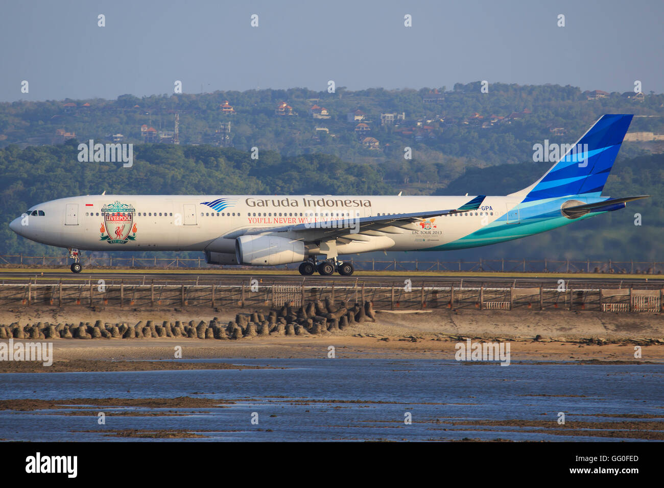 Bali/Indonesia Februar 19, 2013: Airbus A330 from Garuda Airliners with Liverpool colours takeoff at Bali Airport. Stock Photo