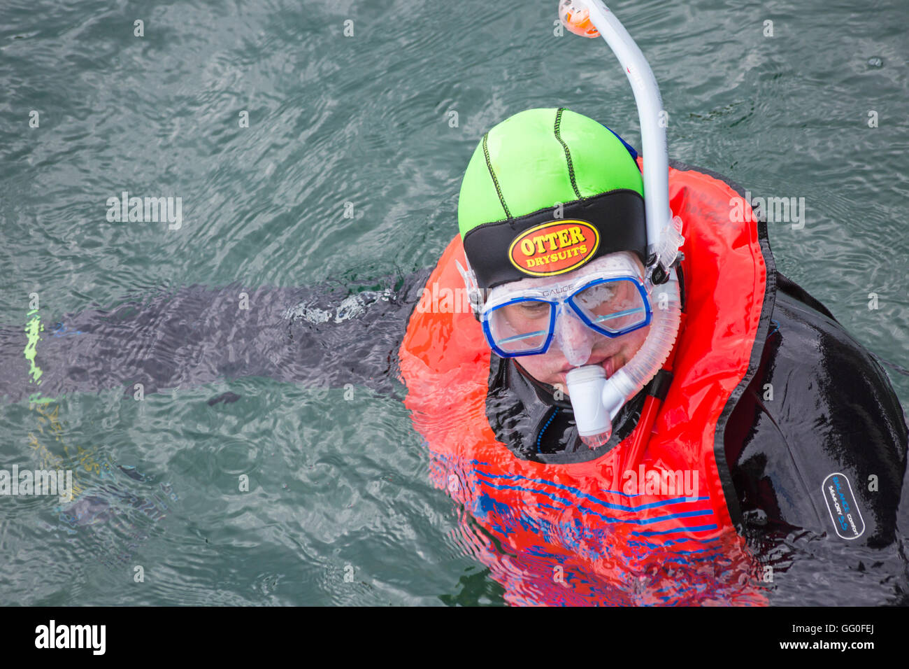 Scuba diver in fluorescent coloured gear in sea at Swanage in July Stock Photo