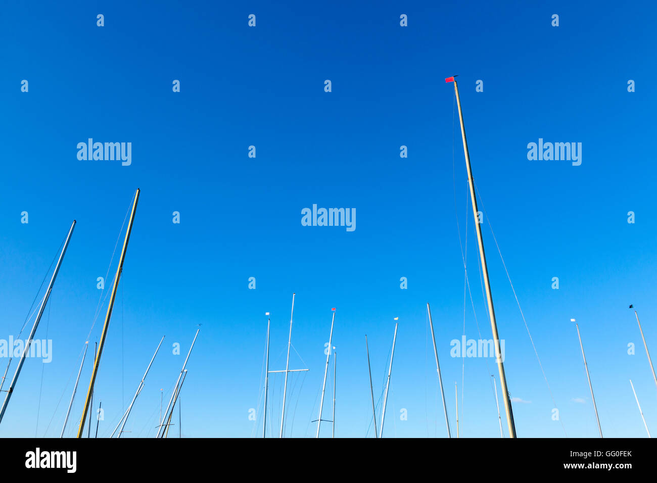Lots of yacht masts against a blue sky, England, UK Stock Photo